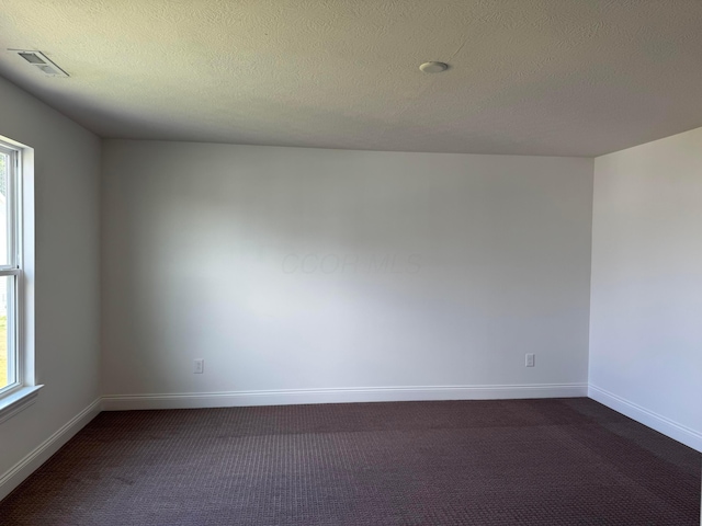 8760 Apricot Way Lot 1917, Plain City, OH 43064 - spare room with dark carpet and a textured ceiling