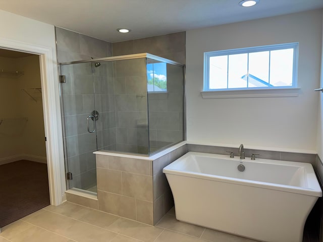 8760 Apricot Way Lot 1917, Plain City, OH 43064 - bathroom featuring tile patterned flooring, a walk in closet, a shower stall, a soaking tub, and recessed lighting