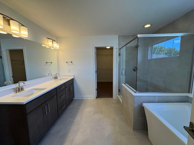 8760 Apricot Way Lot 1917, Plain City, OH 43064 - full bathroom with a spacious closet, a stall shower, double vanity, a soaking tub, and recessed lighting