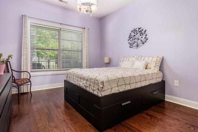4881 Primrose Ct, Grove City, OH 43123 - bedroom with dark wood finished floors and a chandelier