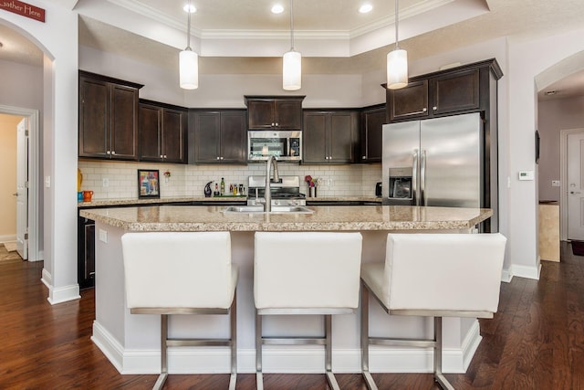 4881 Primrose Ct, Grove City, OH 43123 - kitchen featuring appliances with stainless steel finishes, dark brown cabinets, dark wood-type flooring, ornamental molding, and recessed lighting