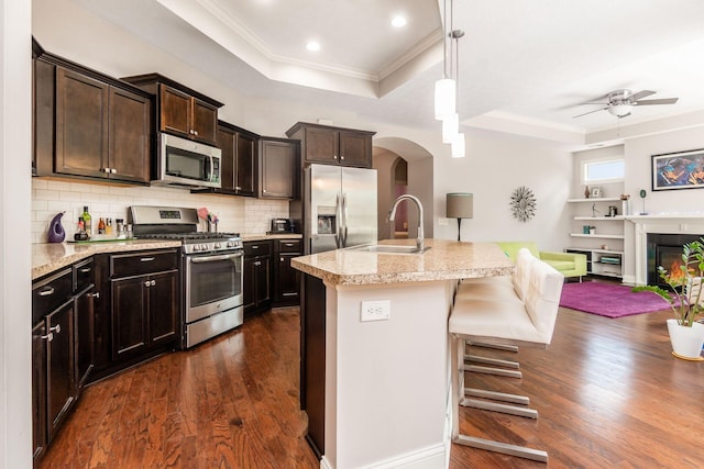 4881 Primrose Ct, Grove City, OH 43123 - kitchen with appliances with stainless steel finishes, a raised ceiling, ornamental molding, dark wood-type flooring, and dark brown cabinetry