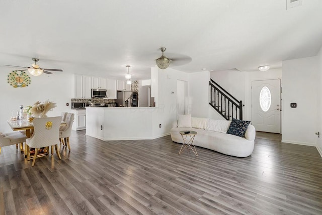 3151 Crossgate Rd, Columbus, OH 43232 - living room featuring ceiling fan, stairs, and dark wood-style flooring