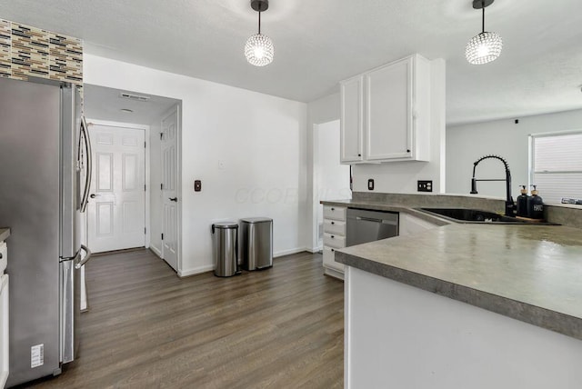 3151 Crossgate Rd, Columbus, OH 43232 - kitchen with stainless steel appliances, dark wood finished floors, white cabinets, and hanging light fixtures