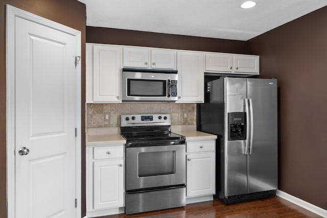 3839 Rubythroat Dr, Columbus, OH 43230 - kitchen with stainless steel appliances, light countertops, dark wood-type flooring, and white cabinetry