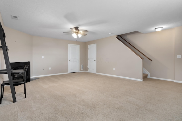 3839 Rubythroat Dr, Columbus, OH 43230 - unfurnished living room featuring ceiling fan, light colored carpet, and stairs