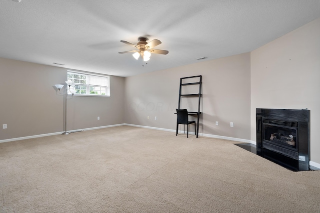 3839 Rubythroat Dr, Columbus, OH 43230 - unfurnished living room featuring ceiling fan, carpet flooring, a textured ceiling, and a fireplace with flush hearth