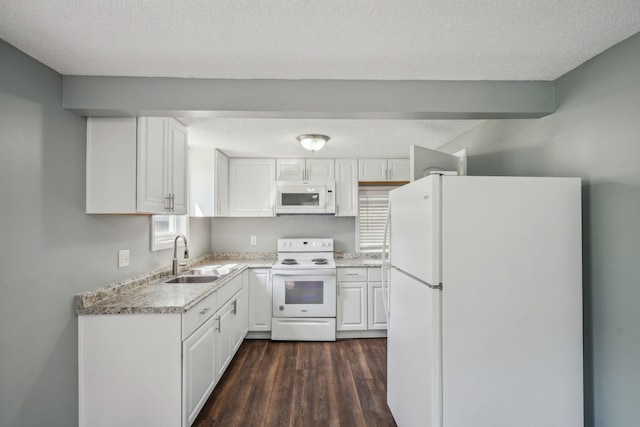 2292 Traymore Pl, Columbus, OH 43211 - kitchen with white appliances, a textured ceiling, dark wood-style floors, and white cabinetry