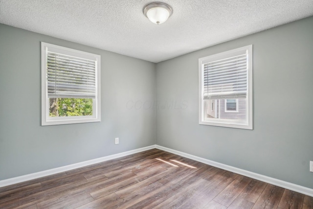 2292 Traymore Pl, Columbus, OH 43211 - empty room with dark wood-type flooring and a textured ceiling