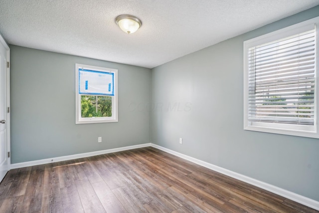 2292 Traymore Pl, Columbus, OH 43211 - empty room with dark wood-style floors and a textured ceiling