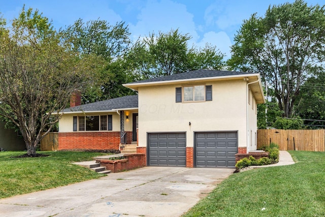 2664 Sonata Dr, Columbus, OH 43209 - tri-level home featuring an attached garage, driveway, stucco siding, a chimney, and brick siding