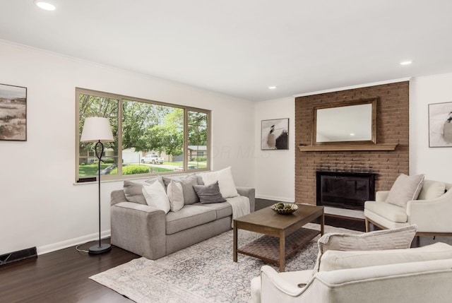 2664 Sonata Dr, Columbus, OH 43209 - living area featuring dark wood finished floors, ornamental molding, recessed lighting, and a fireplace