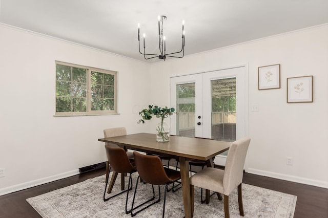 2664 Sonata Dr, Columbus, OH 43209 - dining room featuring french doors, a chandelier, healthy amount of natural light, dark wood-type flooring, and ornamental molding