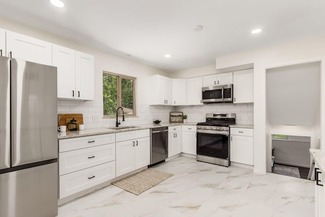 2664 Sonata Dr, Columbus, OH 43209 - kitchen with stainless steel appliances, light stone counters, white cabinetry, decorative backsplash, and recessed lighting
