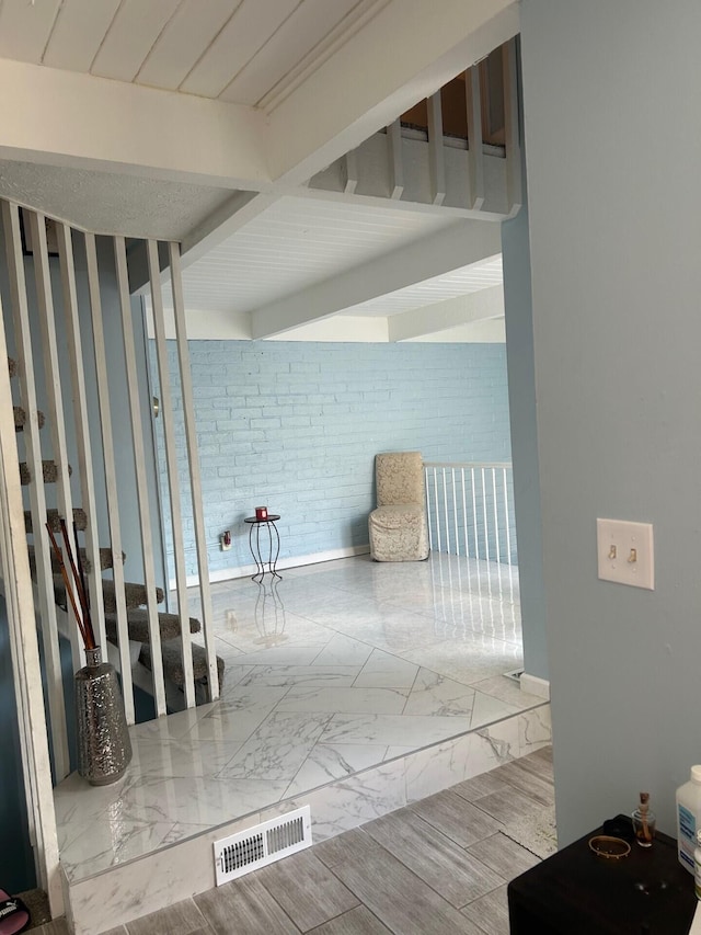 5479 Worthington Forest Pl, Columbus, OH 43229 - corridor featuring brick wall and marble finish flooring
