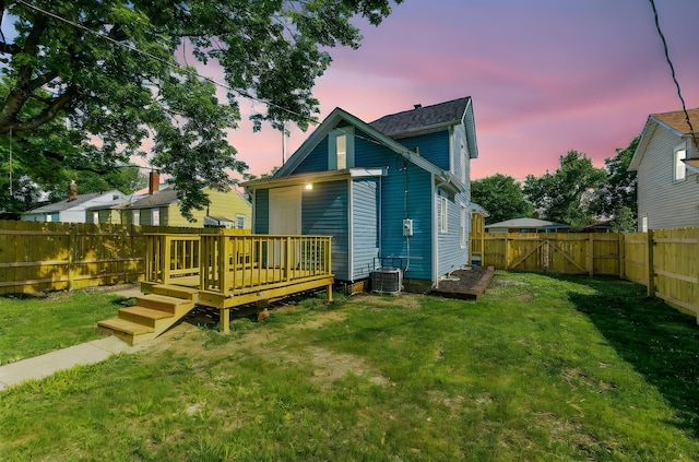 3189 E 6th Ave, Columbus, OH 43219 - back of property at dusk with a gate, a fenced backyard, and a deck
