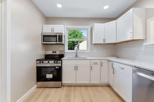3189 E 6th Ave, Columbus, OH 43219 - kitchen with stainless steel appliances, light wood-type flooring, tasteful backsplash, and recessed lighting