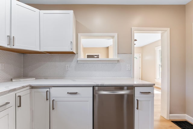 3189 E 6th Ave, Columbus, OH 43219 - kitchen featuring stainless steel dishwasher, white cabinetry, tasteful backsplash, light wood-style flooring, and light stone countertops