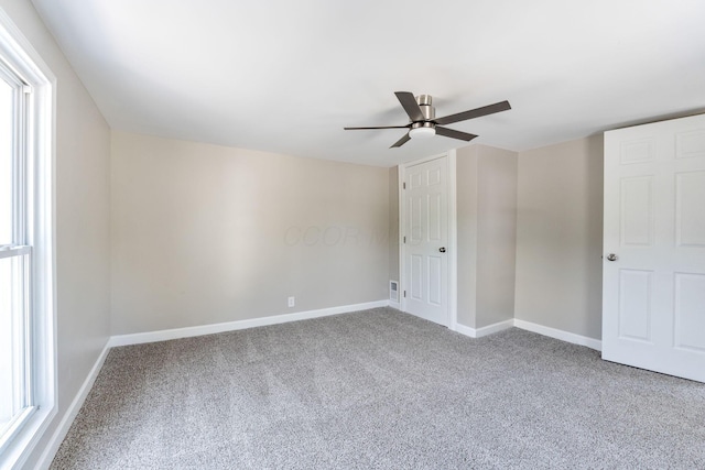 3189 E 6th Ave, Columbus, OH 43219 - unfurnished bedroom featuring carpet, a ceiling fan, and multiple windows
