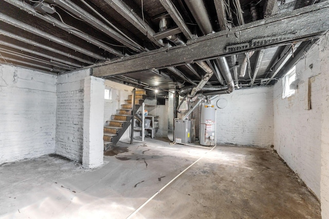 3189 E 6th Ave, Columbus, OH 43219 - below grade area with water heater, stairs, heating unit, and brick wall