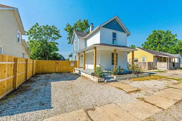 3189 E 6th Ave, Columbus, OH 43219 - view of front of home with covered porch, a chimney, and roof with shingles