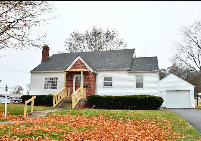 267 Strayer Ave, Bremen, OH 43107 - view of front of home featuring a chimney, a garage, an outdoor structure, and a shingled roof