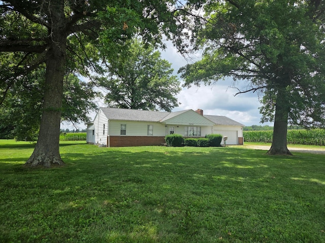 7376 Mink St SW, Pataskala, OH 43062 - ranch-style home with a garage, a front lawn, a chimney, driveway, and brick siding