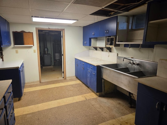 7376 Mink St SW, Pataskala, OH 43062 - kitchen featuring blue cabinetry, open shelves, light countertops, light flooring, and a paneled ceiling