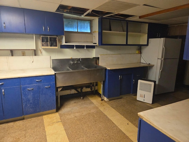7376 Mink St SW, Pataskala, OH 43062 - kitchen featuring blue cabinets, open shelves, freestanding refrigerator, and light flooring