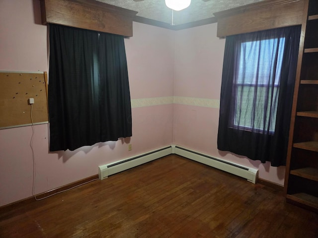 7376 Mink St SW, Pataskala, OH 43062 - spare room featuring wood finished floors, a textured ceiling, ceiling fan, and baseboard heating