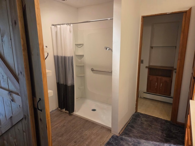 7376 Mink St SW, Pataskala, OH 43062 - bathroom featuring a baseboard radiator, a shower stall, and wood finished floors