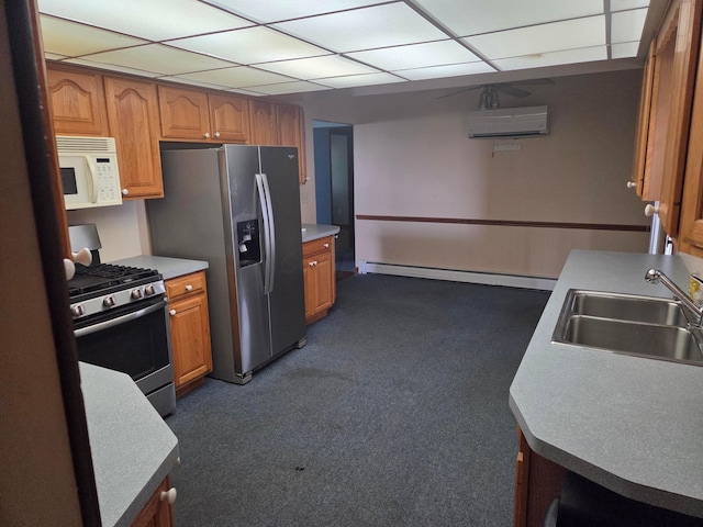 7376 Mink St SW, Pataskala, OH 43062 - kitchen featuring appliances with stainless steel finishes, a wall mounted air conditioner, baseboard heating, dark carpet, and a drop ceiling