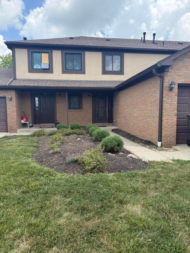 2022 Queensgate Ln, Columbus, OH 43235 - traditional-style home featuring an attached garage, a front yard, and brick siding