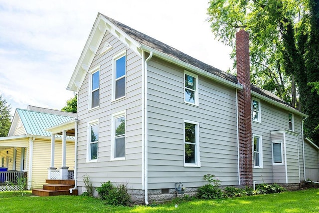 186 S Walnut St, Chillicothe, OH 45601 - back of property with a lawn, a chimney, and covered porch