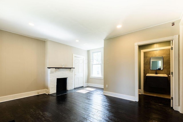 186 S Walnut St, Chillicothe, OH 45601 - unfurnished living room with dark wood-type flooring, a brick fireplace, and recessed lighting
