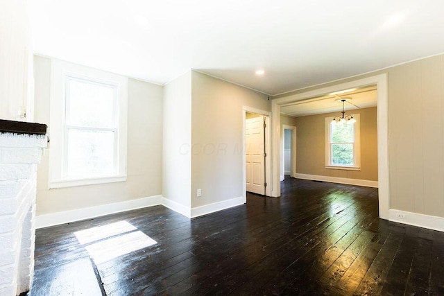 186 S Walnut St, Chillicothe, OH 45601 - unfurnished living room with wood-type flooring and a chandelier