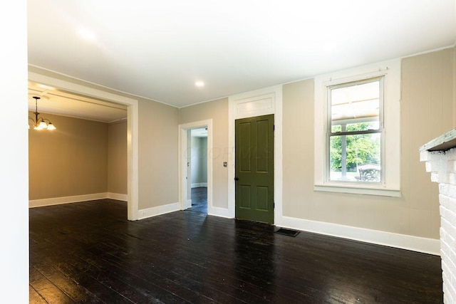 186 S Walnut St, Chillicothe, OH 45601 - unfurnished living room with dark wood finished floors and a chandelier