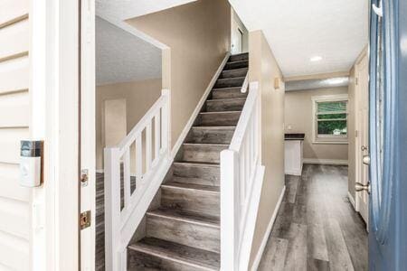 5200 Garmouth Ct, Columbus, OH 43221 - stairs with baseboards and wood finished floors