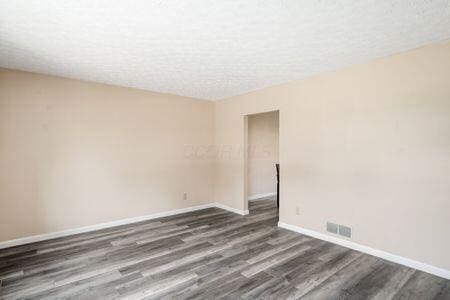 5200 Garmouth Ct, Columbus, OH 43221 - empty room with wood finished floors and a textured ceiling