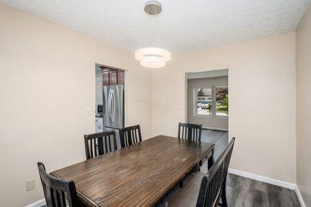 5200 Garmouth Ct, Columbus, OH 43221 - dining room featuring a chandelier and dark wood-style flooring
