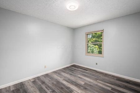 5200 Garmouth Ct, Columbus, OH 43221 - spare room with wood finished floors and a textured ceiling