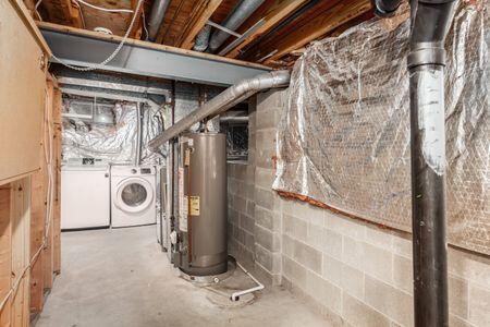 5200 Garmouth Ct, Columbus, OH 43221 - unfinished below grade area with gas water heater and washer and dryer