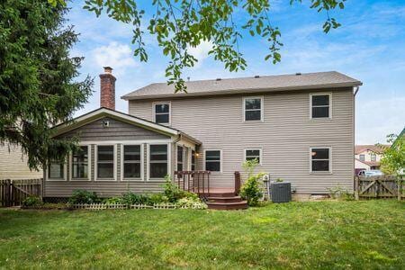 5200 Garmouth Ct, Columbus, OH 43221 - back of property with a fenced backyard, a deck, a chimney, and a sunroom