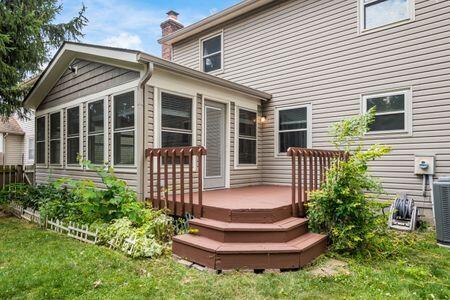 5200 Garmouth Ct, Columbus, OH 43221 - back of property with a wooden deck, a chimney, and a lawn