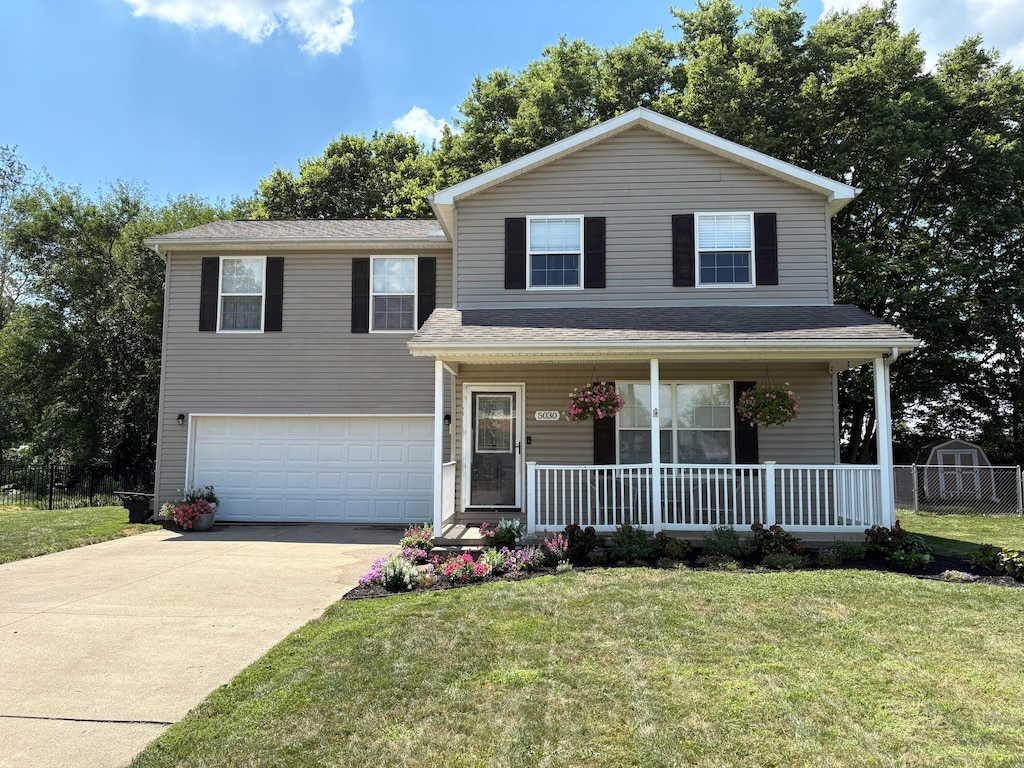 5030 Lee Rd, South Bloomfield, OH 43103 - traditional-style home featuring a garage, covered porch, and driveway