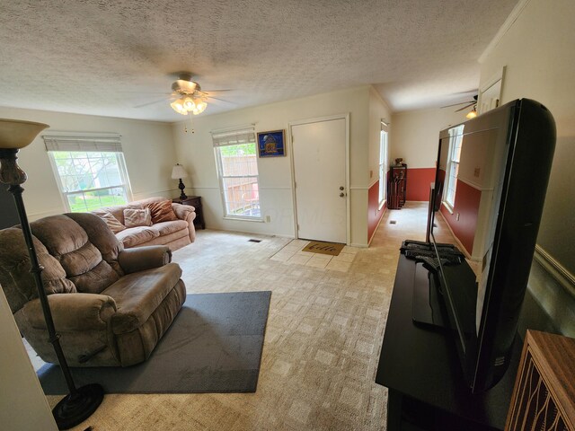 450 Williamsburg Ln Unit A, Lancaster, OH 43130 - living room featuring a ceiling fan, a textured ceiling, and light carpet