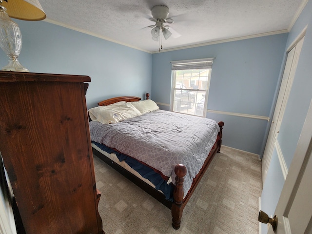 450 Williamsburg Ln Unit A, Lancaster, OH 43130 - carpeted bedroom featuring ornamental molding, a textured ceiling, ceiling fan, and a closet