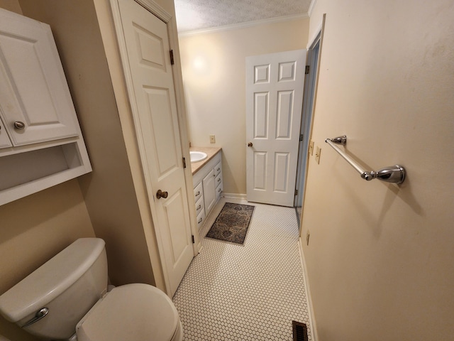 450 Williamsburg Ln Unit A, Lancaster, OH 43130 - bathroom featuring vanity, a textured ceiling, and ornamental molding