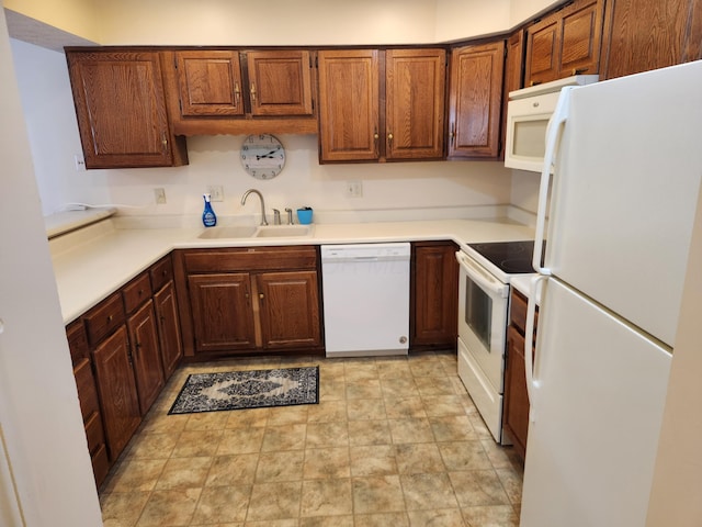 450 Williamsburg Ln Unit A, Lancaster, OH 43130 - kitchen featuring white appliances, light countertops, brown cabinetry, and stone finish floors