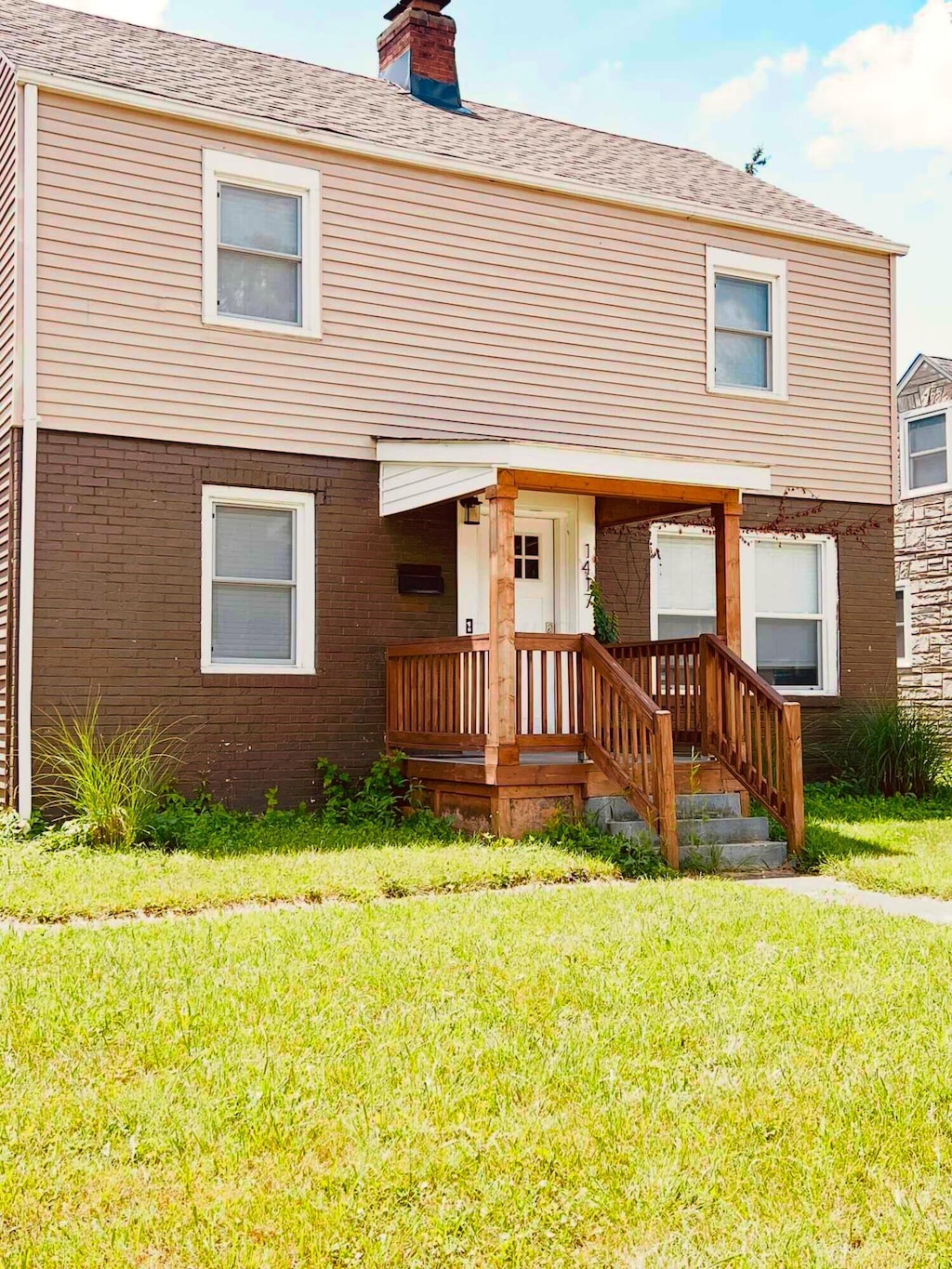 1417 E Whittier St, Columbus, OH 43206 - view of front of house with a front lawn, a chimney, and brick siding